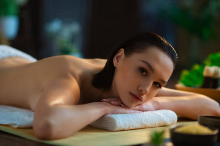 Young woman getting massaging treatment over exotic background. Spa, healthcare and recreation concept.の写真素材