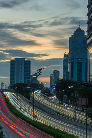Silhouette of traffic in Jakarta at sunset.の写真素材