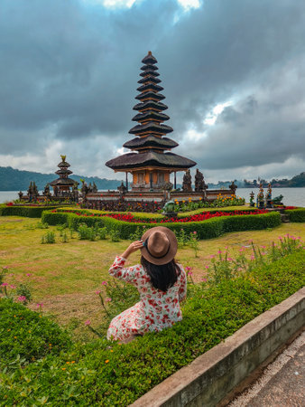 Woman tourist in Pura Ulun Danu Bratan temple in Bali, Indonesiaの写真素材