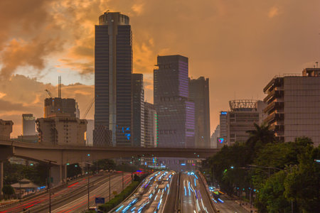 Traffic on the road in Bangkok at sunset.