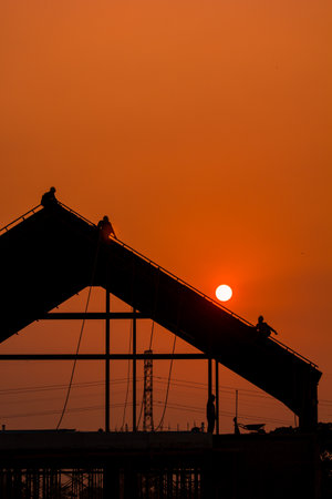 Silhouette of construction site at sunset in Bangkok, Thailand.の写真素材