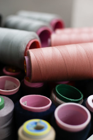 bobbins of multi-colored threads lie on each other
