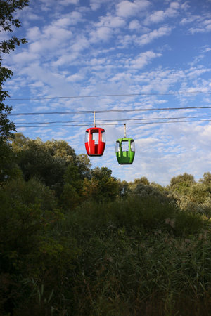 red and green cable car cabins against the sky