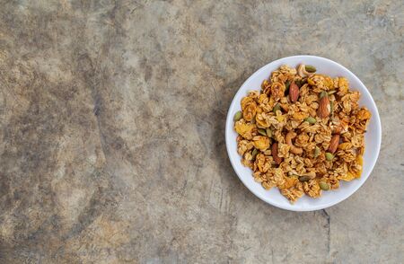 Homemade granola cereal with oatmeal, almond, cashews nut and pumpkin from top view.の写真素材