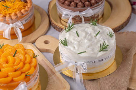Chiffon coconut cake decorated with rosemary on wooden board.の写真素材