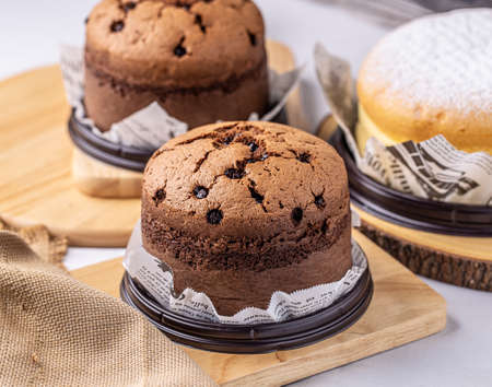 Mini chocolate Taiwanese castella cake on white paper with wooden board.の写真素材