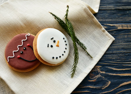 Gingerbread cookies and a linen towel on a dark wooden background. Christmas background.