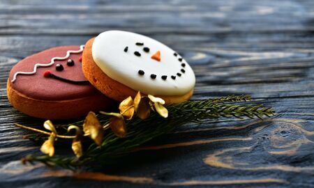 Gingerbread cookies and Christmas decorations on a dark wooden background. Side view. Festive background.の写真素材
