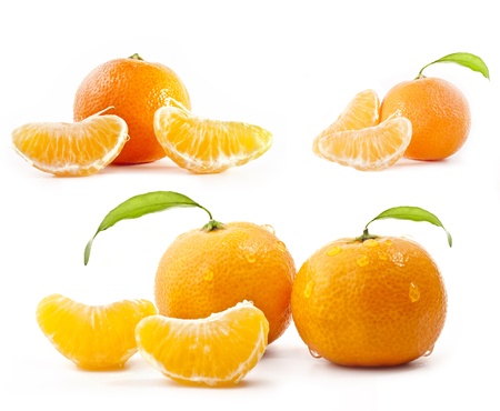 Tangerines with water drops and green leavesの写真素材
