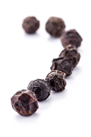 Black peppercorns isolated on white background の写真素材