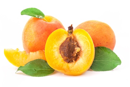 Apricot fruits and slices with green leaves, isolated on white backgroundの写真素材