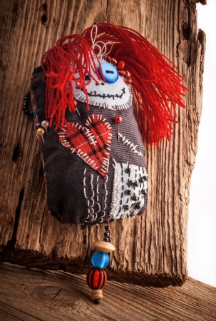 Handmade Pincushion  voodoo doll  on wooden backgroundの写真素材