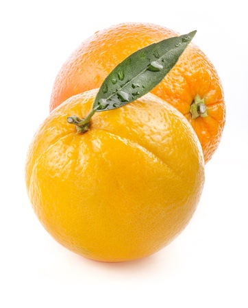 Ripe orange fruit with leaf and water drops isolated on white backgroundの写真素材