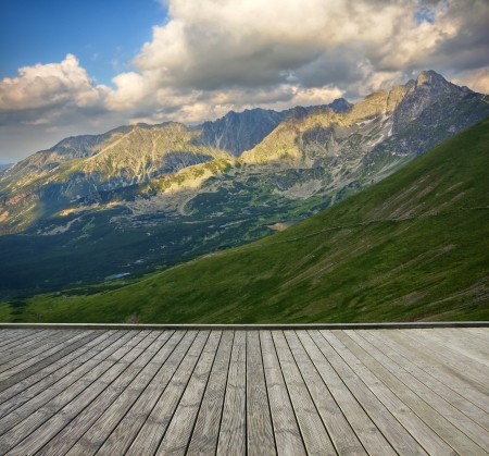 Empty wooden terrace with mountain landscape in the backgroundの写真素材