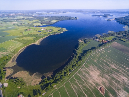 Aerial view of beautiful landscape of lake district, Mamry Lake in the foreground, Upalty in the distance - the biggest island of Mazury region, Polandの写真素材