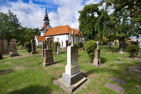 NEXO, DENMARK - AUGUST 20, 2018: View of St Nicholas Church from the graveyardのeditorial素材