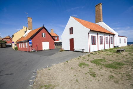 Small colorful half-timbered houses with smokery chimneys in Gudhjem, Bornholm, Denmark.の写真素材