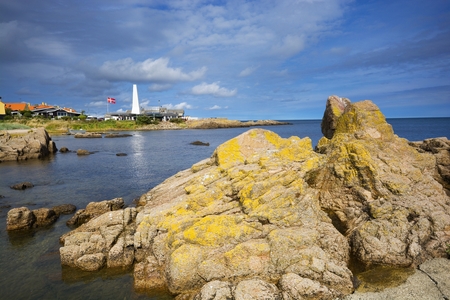 Rocky coast of Baltic Sea in Allinge, Bornholm, Denmark. Chimney of smokehouse in the background.の写真素材