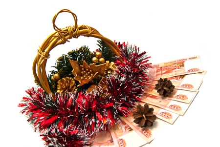 Basket with pinecones, money and tinsel on whiteの写真素材
