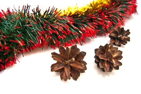 Three pinecones and tinsel on white backgroundの写真素材