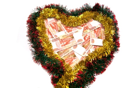 Money on tinsel heart. On white backgroundの写真素材
