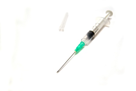 Syringe and cap on white backgroundの写真素材