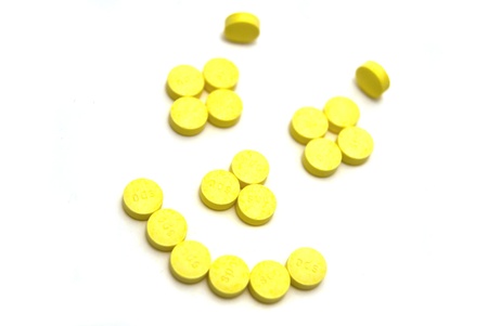 Smiling face pills on white backgroundの写真素材
