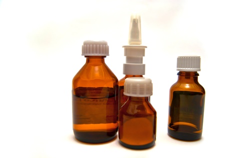 Four bottles of different medicine on white backgroundの写真素材