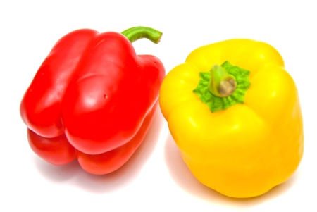 Red and yellow peppers on white の写真素材