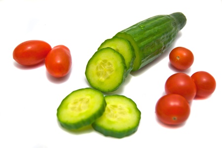 cucumber and cherry tomatoes on white backgroundの写真素材