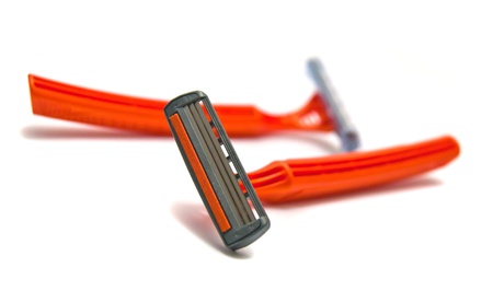 two orange razor blades on whiteの写真素材