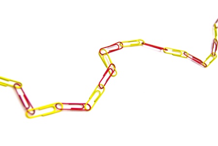 red and yellow paper clips on whiteの写真素材