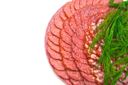 sausage with herbs on plate on white backgroundの写真素材