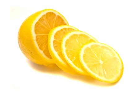 Lemon slices and fresh lemon on whiteの写真素材