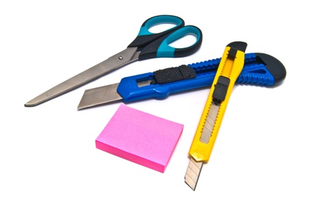 two knives, scissors and stickers on white backgroundの写真素材