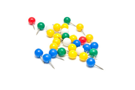 colorful stationery pins on white background