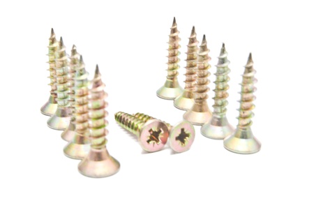 many golden screws on whiteの写真素材