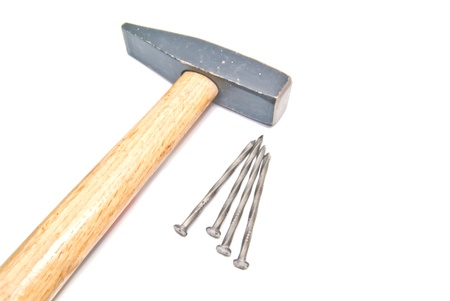 hammer and four nails on white backgroundの写真素材
