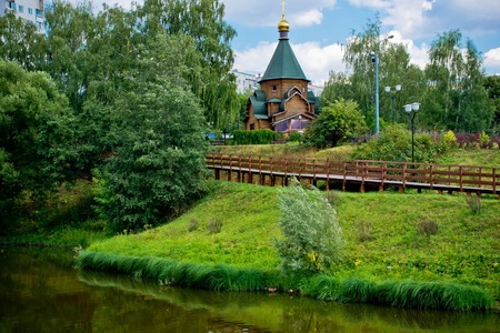 wooden chapel on the shore of a calm riverの写真素材