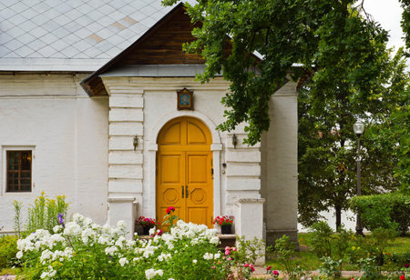 house of white stone among the flower beds