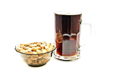dark beer and pistachios on white background closeupの写真素材