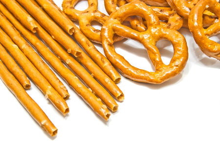 breadsticks and salted pretzels on white background closeup