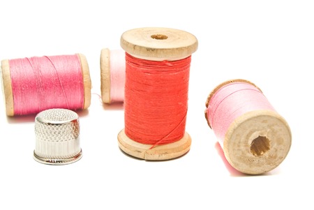 thimble and spools of thread closeup on whiteの写真素材