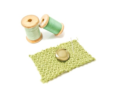 spools of thread and button on whiteの写真素材