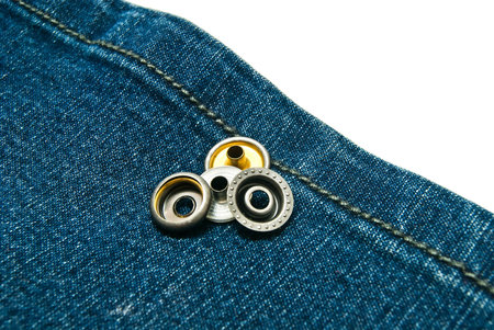 blue denim with metal buttons on white closeupの写真素材