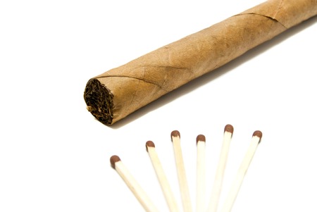 single cigar and few matches closeup on whiteの写真素材