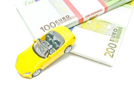 euro notes and yellow car on white backgroundの写真素材