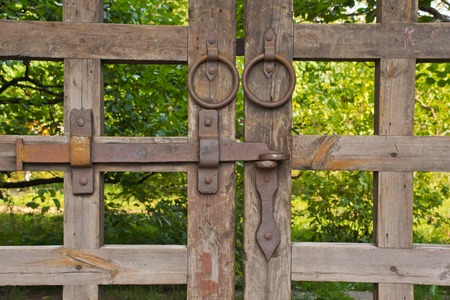 old wooden gate among the foliage in the parkの写真素材