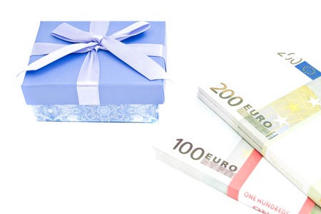 blue gift box and banknotes closeup on white backgroundの写真素材