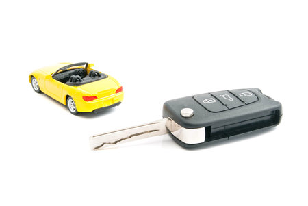 keys and yellow sport car on whiteの写真素材